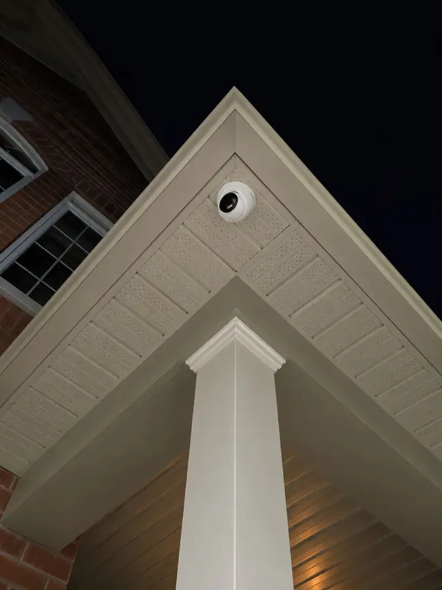 Security camera on a gable peak at night in Burlington